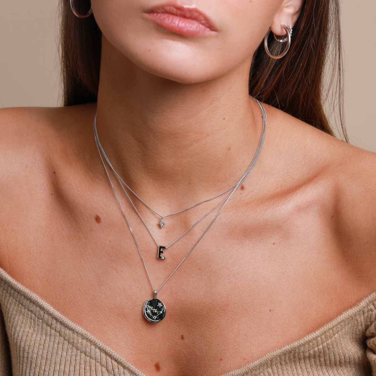 E Initial Pendant Necklace in Silver worn layered with etched pendant necklace and zodiac pendant necklace