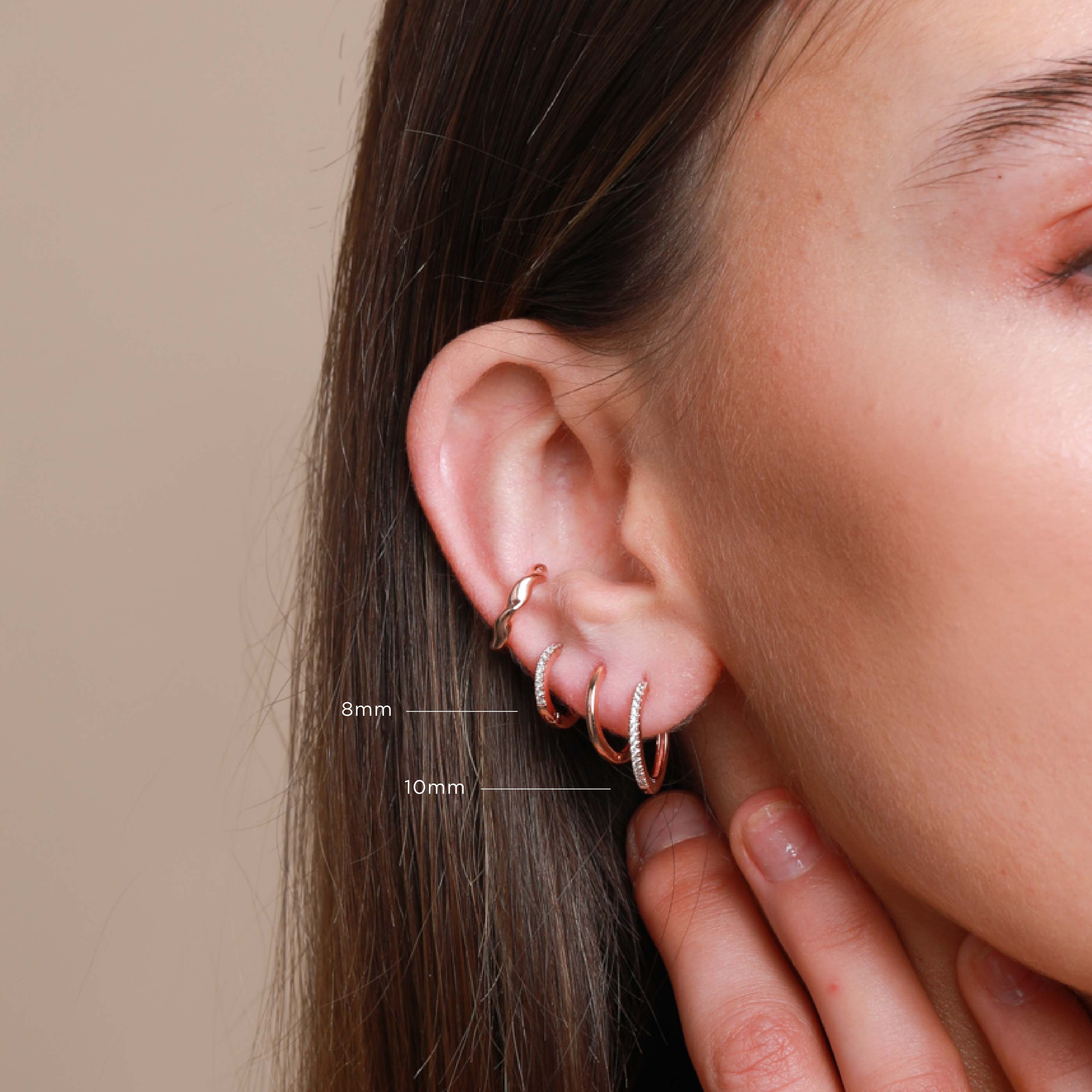 Worn shot of Jewelled Hoop 8mm in Rose Gold in upper lobe piercing location with sizes labelled
