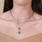 Worn shot of Essential Pendant Necklace in Silver layered with Molten Coin Necklace in Silver and Duo Chain necklace in silver.