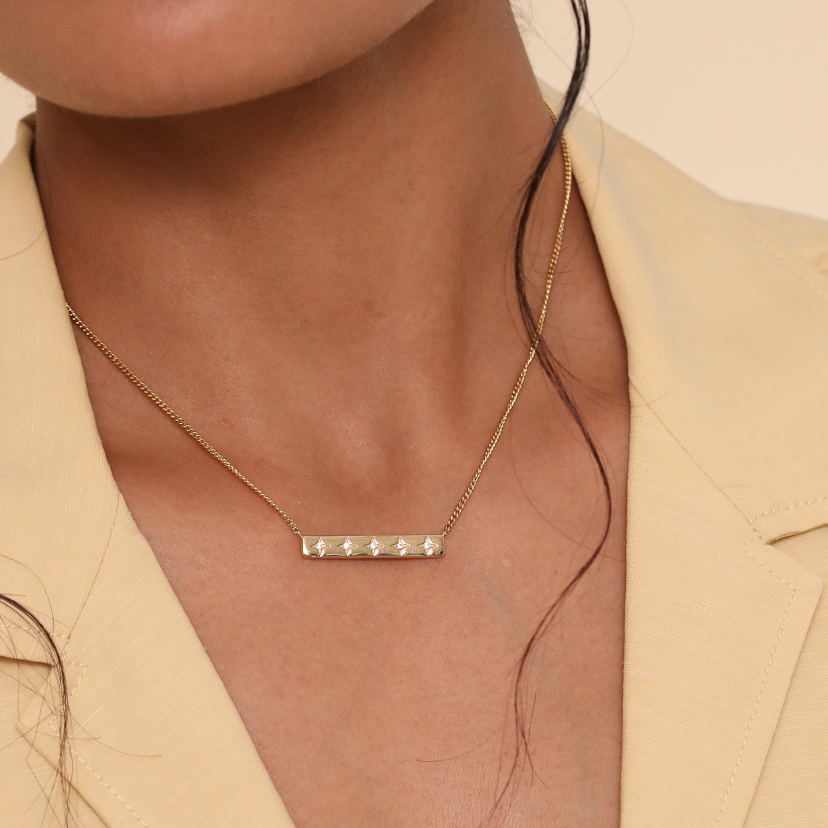 Cosmic Star Bar Necklace in Gold worn