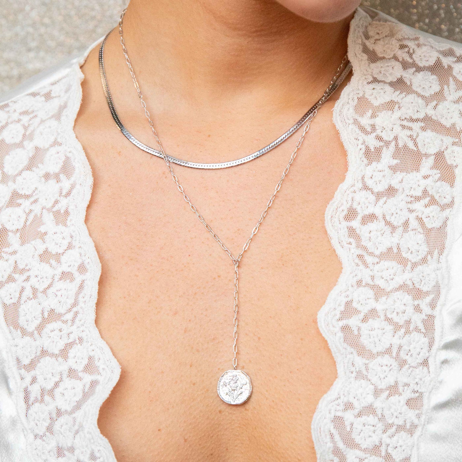 silver snake chain worn with lariat necklace