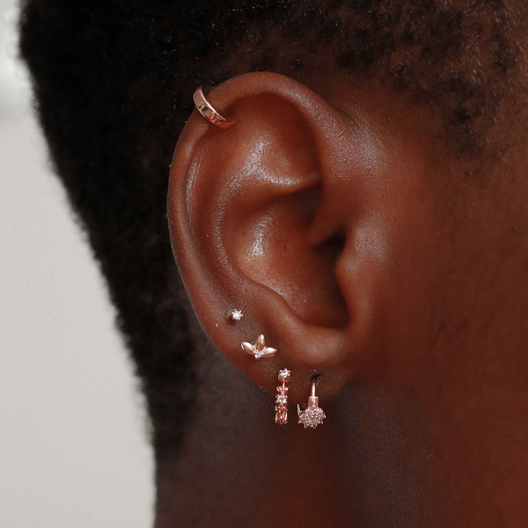 Flora Tiny Barbell in Rose Gold worn in fourth lobe piercing