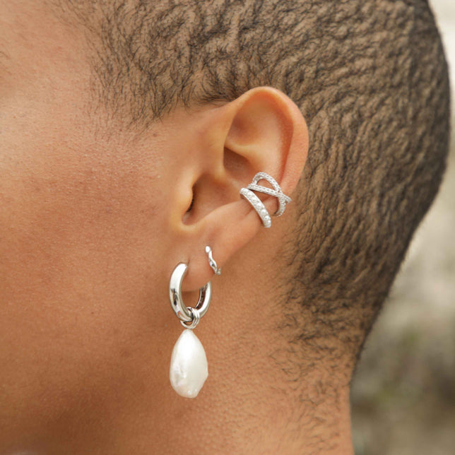 Elemental Huggies in Silver worn with Illume Pearl Hoops and ear cuffs