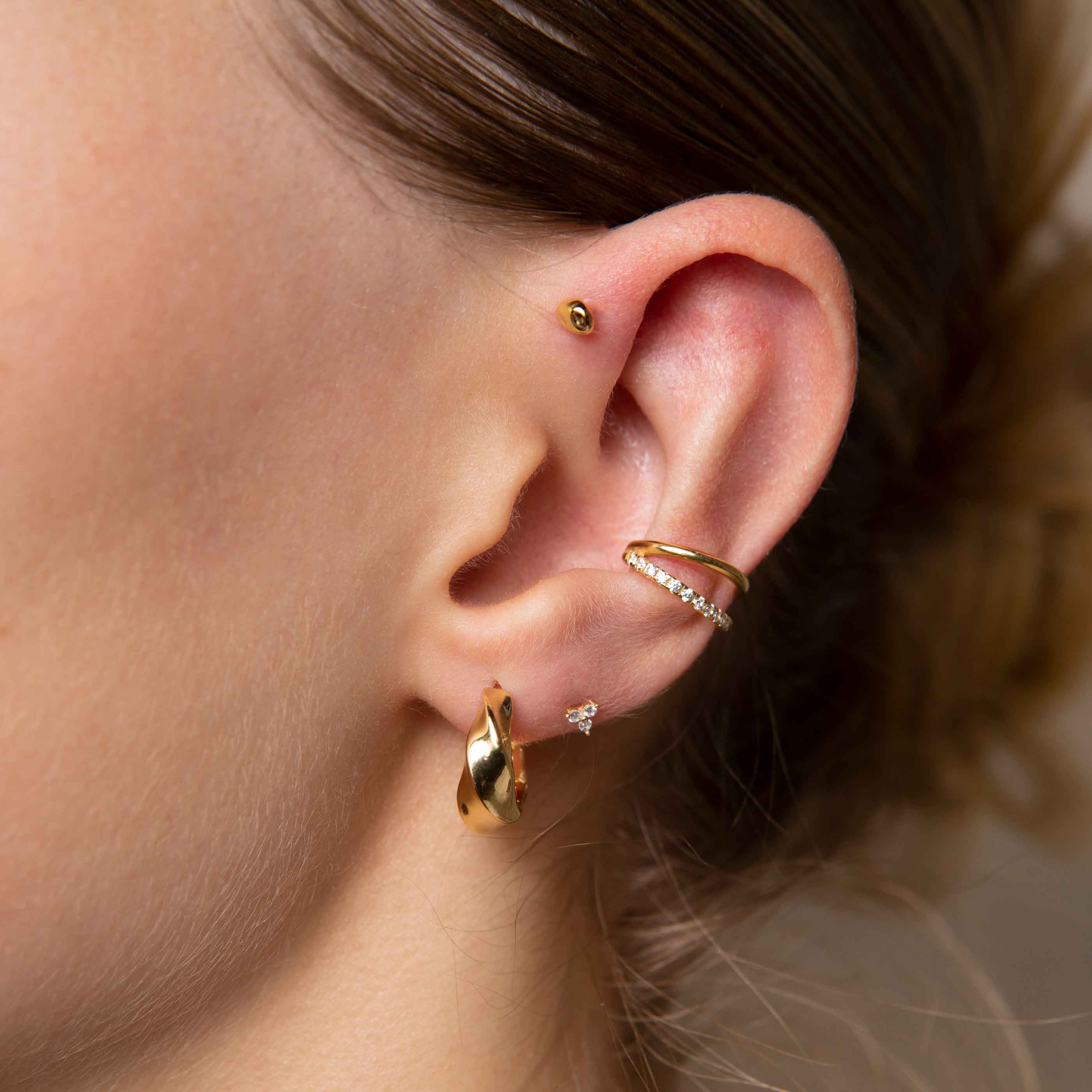 Illusion Crystal Ear Cuff in Gold worn with elemental hoops and triple crystal stud earrings