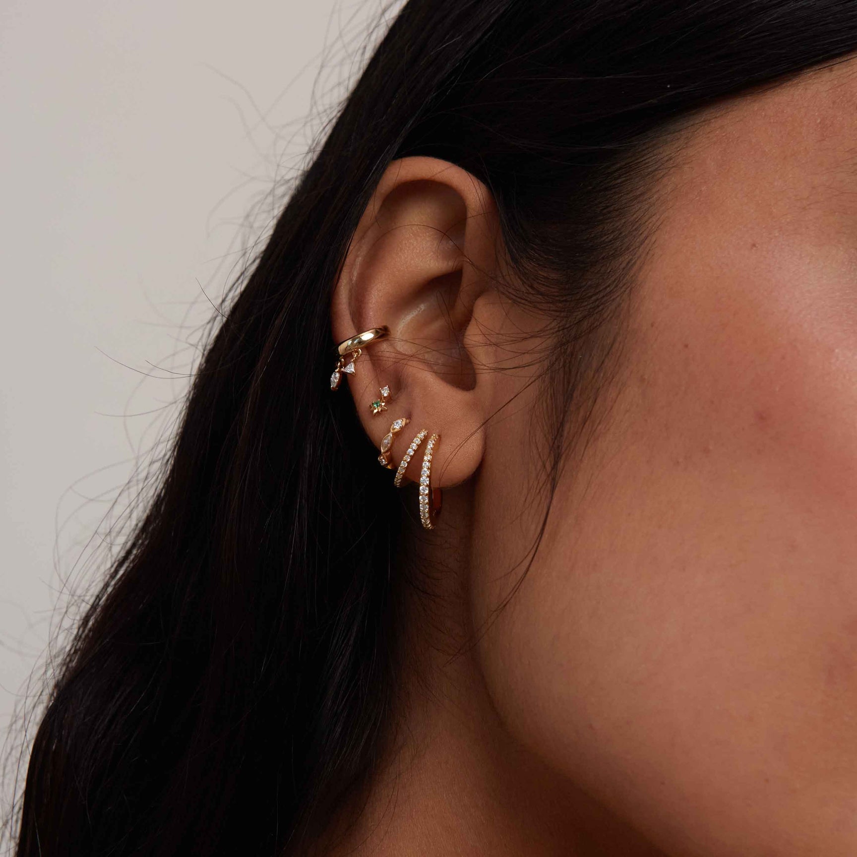Illusion Hoops in Gold stacked with other gold earrings