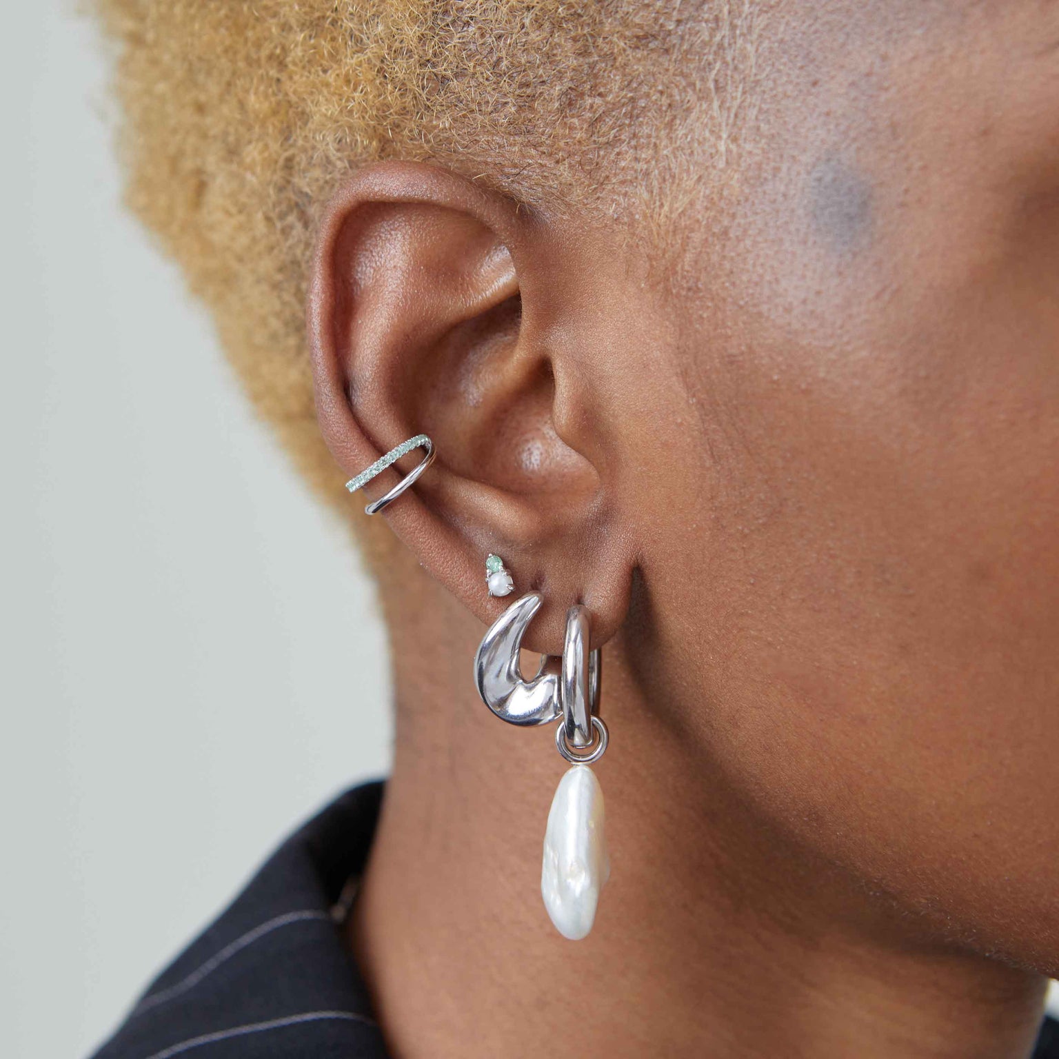 Molten hoops in silver worn with other silver earrings