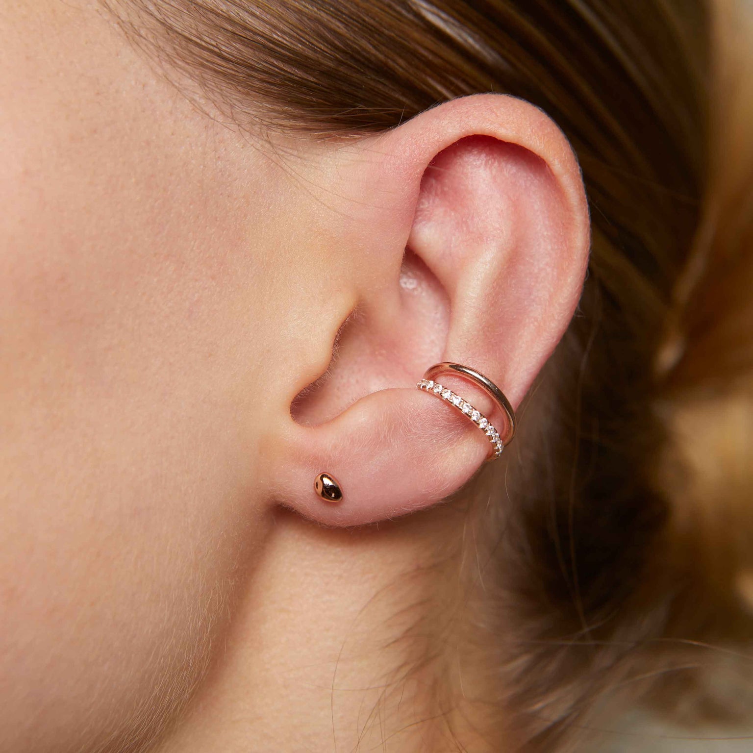 Molten Stud Earrings in Rose Gold worn with illusion crystal ear cuff