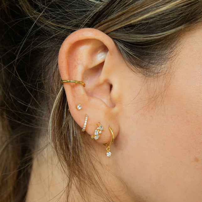 Worn shot of Crystal Stud Earrings in Gold in upper lobe piercing