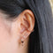 Navette Stud Earrings in Rose Gold worn in second lobe piercing