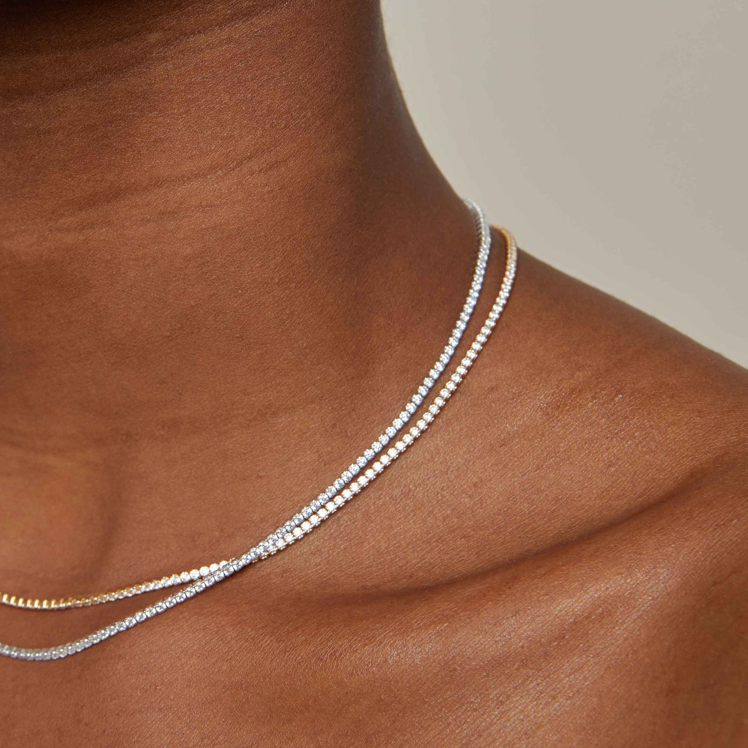 Tennis Chain Necklace in Gold layered with Tennis Chain Necklace in Silver